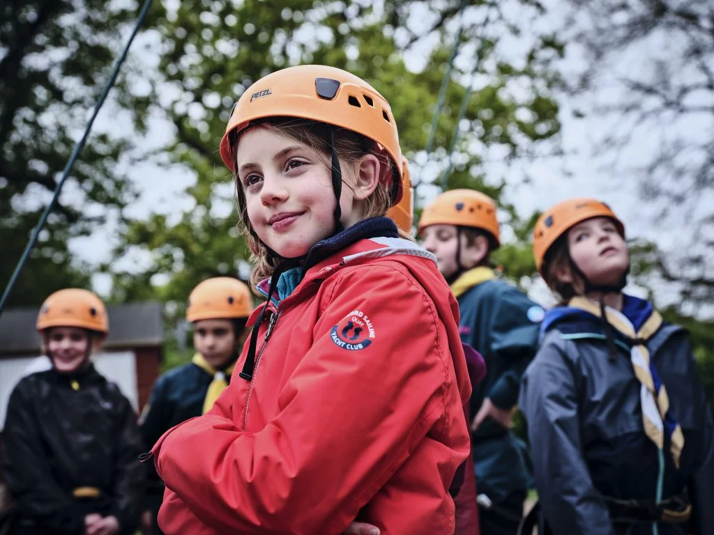 A group of Scouts wearing climbing helmets